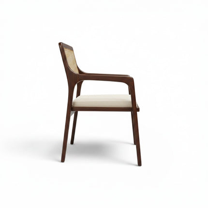 Gharnish Vanya Teakwood Cane Chair with natural cane back and seat, brown polish, and cream cushion.